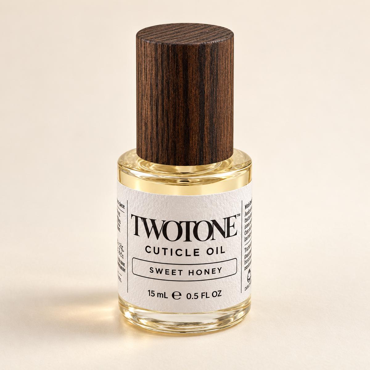 TWOTONE Sweet Honey Cuticle Oil in its clear 15 mL bottle with dark wood cap