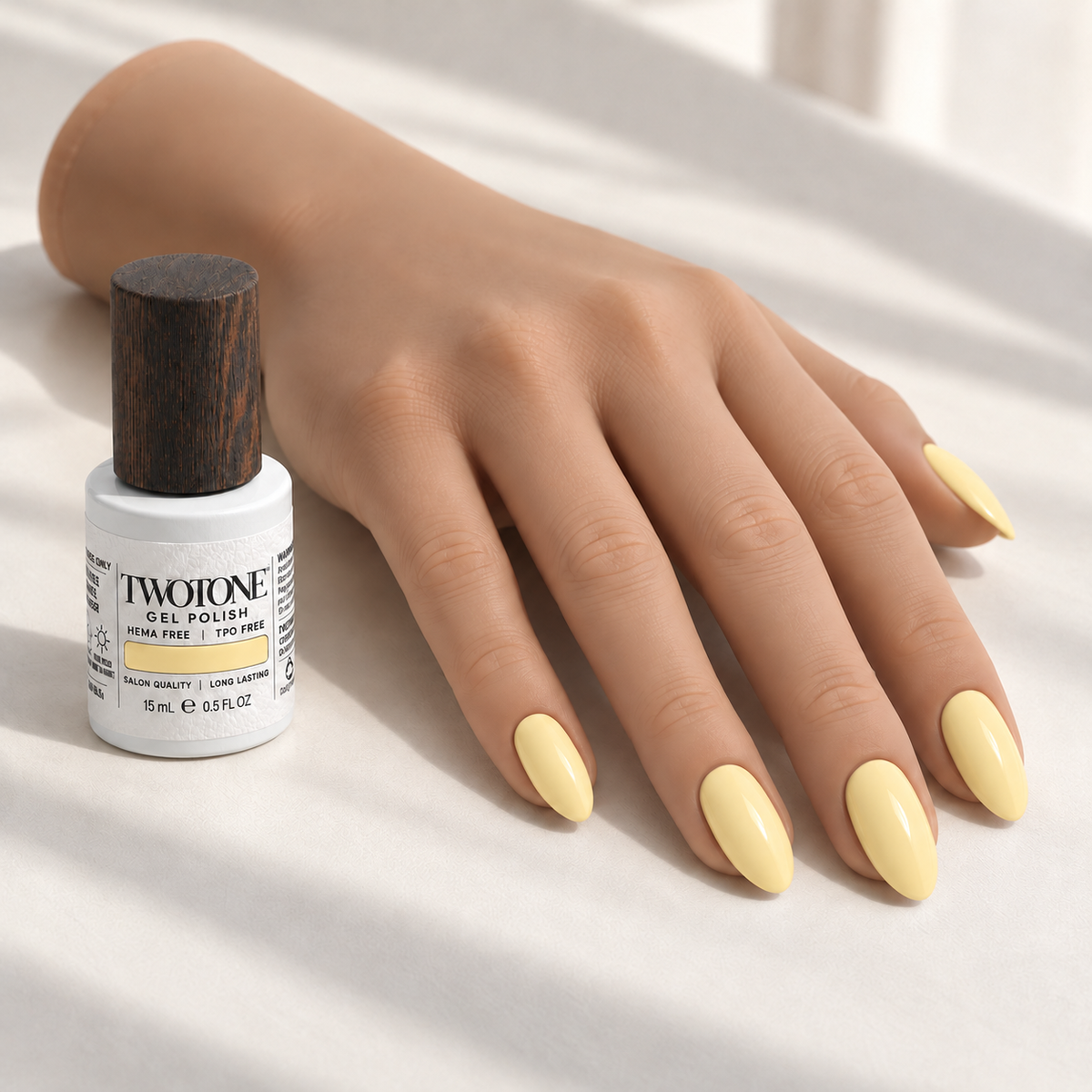 Illustrative Downy Chick manicure on a silicone practice hand beside the TWOTONE bottle; color appearance may vary