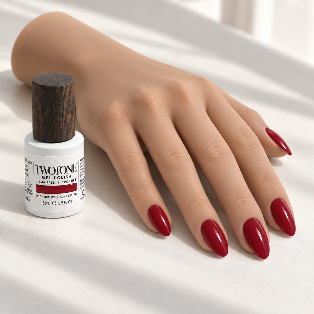 Illustrative Rooster Red manicure on a silicone practice hand beside the TWOTONE bottle; color appearance may vary